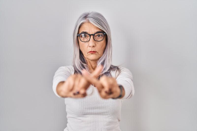 Mature Woman Holding Up hands to say "stay back."